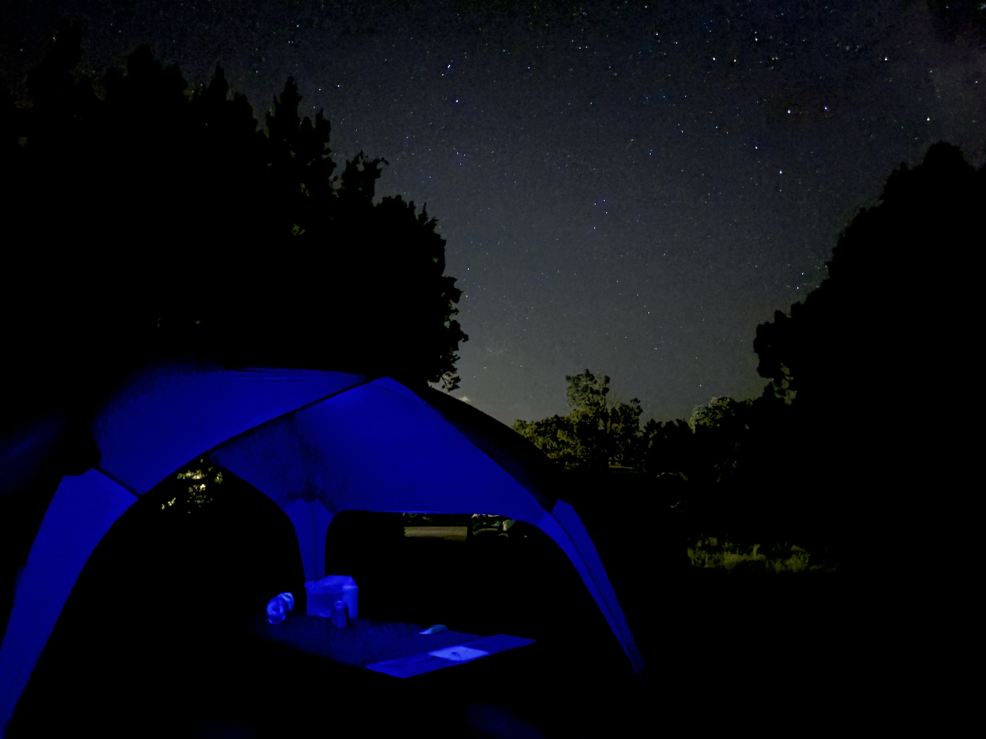 Dark sky over shelter, softly lit in purple