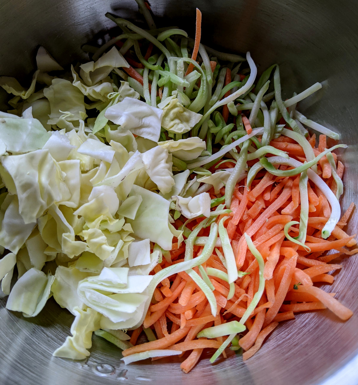 Shredded vegetables in steel bowl